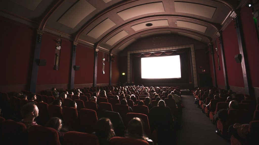 A group of people watching a movie in a theater.