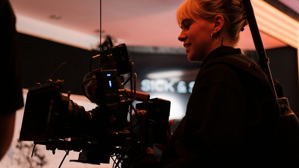 A woman standing in front of a camera.