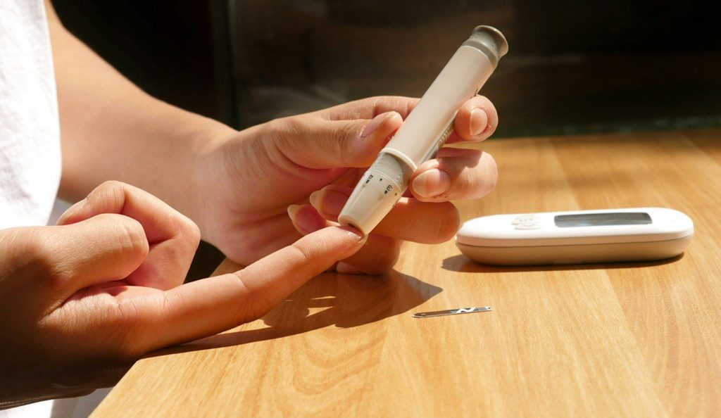 A person checking blood sugar level.