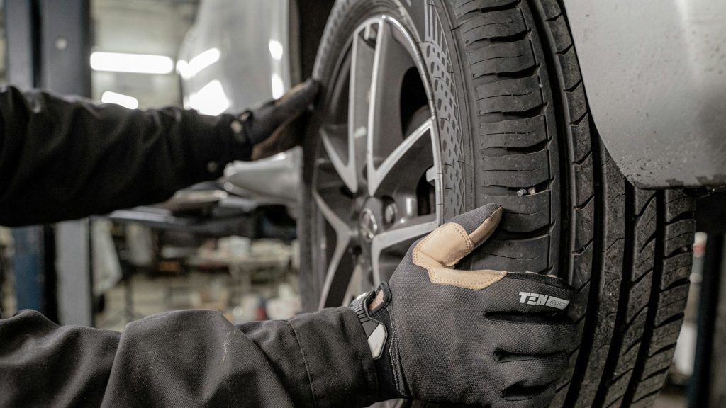 A person working on a tire in a garage.