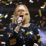 Adele performing at a live concert.