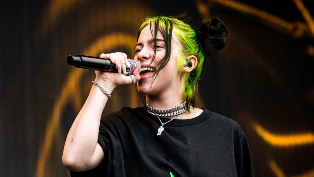 Billie Eilish performing at a live concert.