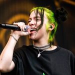 Billie Eilish performing at a live concert.