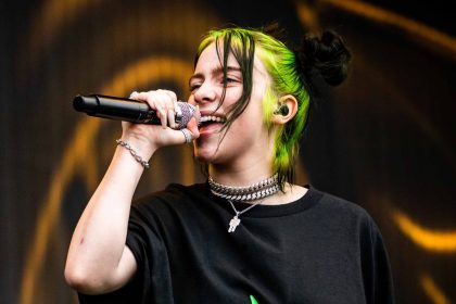 Billie Eilish performing at a live concert.