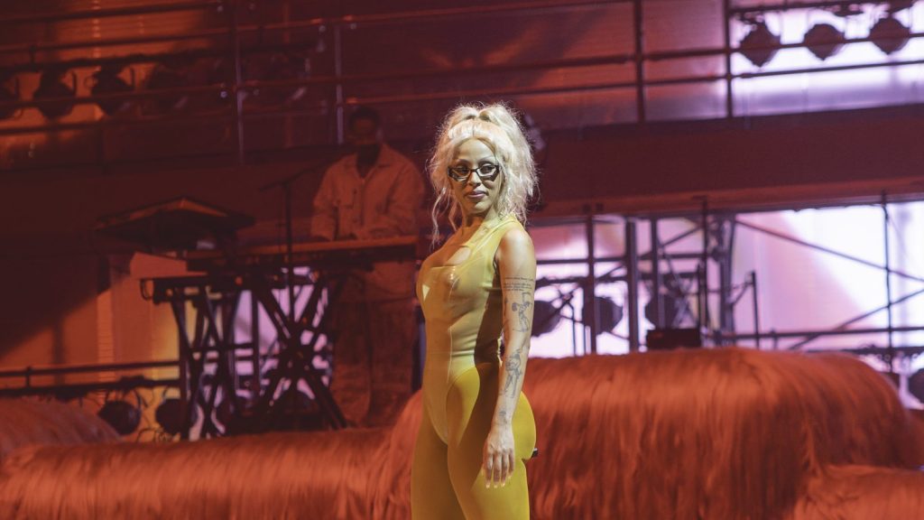 Doja Cat performing at a live event.