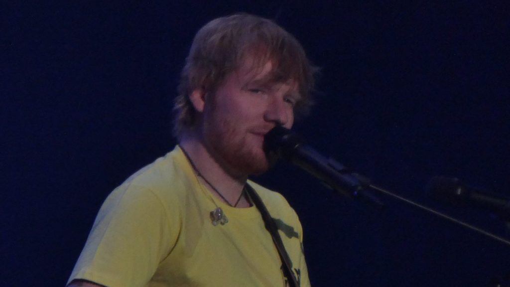 Ed Sheeran performing at the concert.