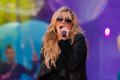 Kesha performing at a live concert.