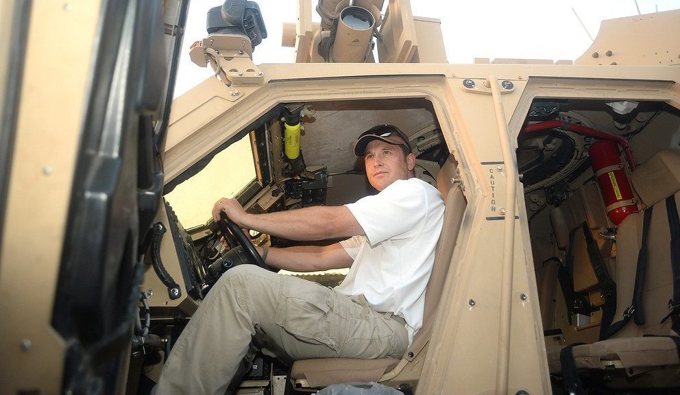 Cole Hauser riding a truck.