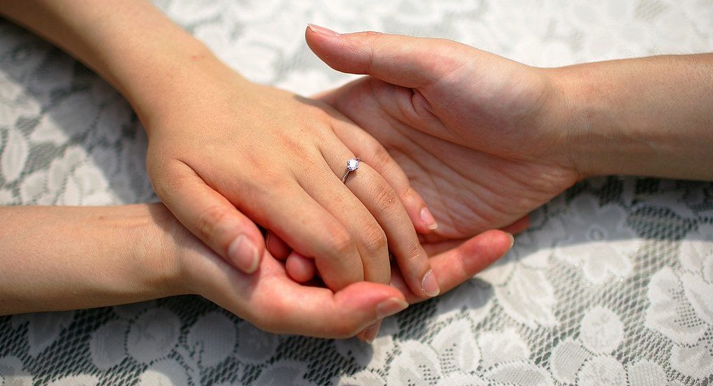 A couple holding hands.