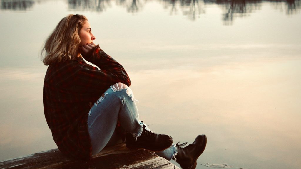 Woman on a wooden bench.