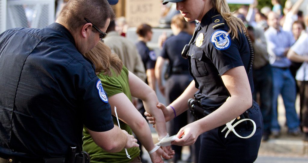 Police arresting a woman.