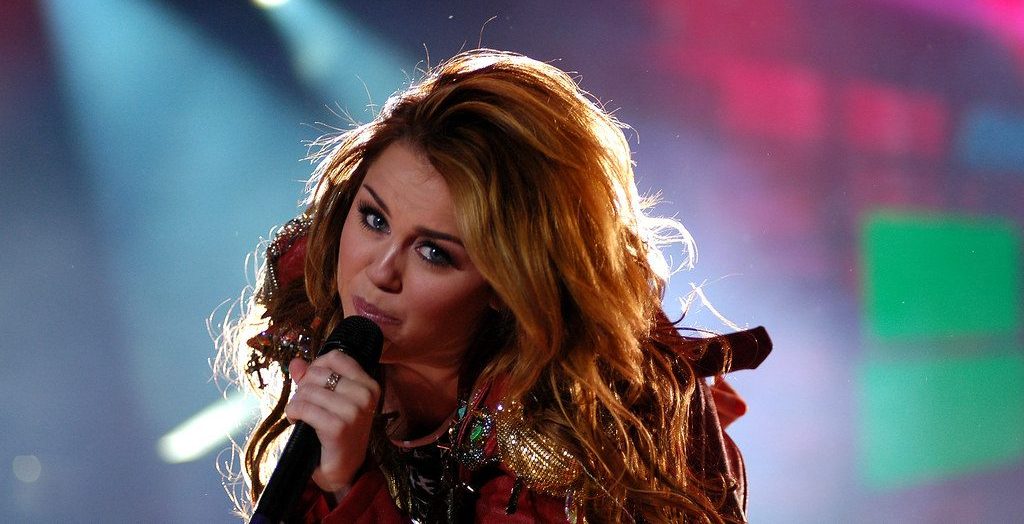 Miley Cyrus performing at the concert.