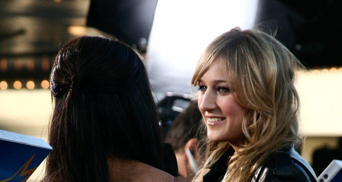 Leelee Sobieski being interviewed at an event.