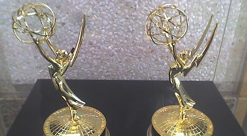 The Emmy Awards kept on a black surface.