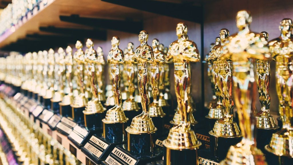 A group of golf trophies kept on the shelf.