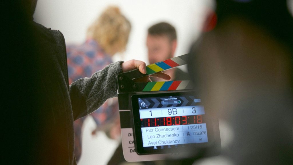 Person holding clapperboard.