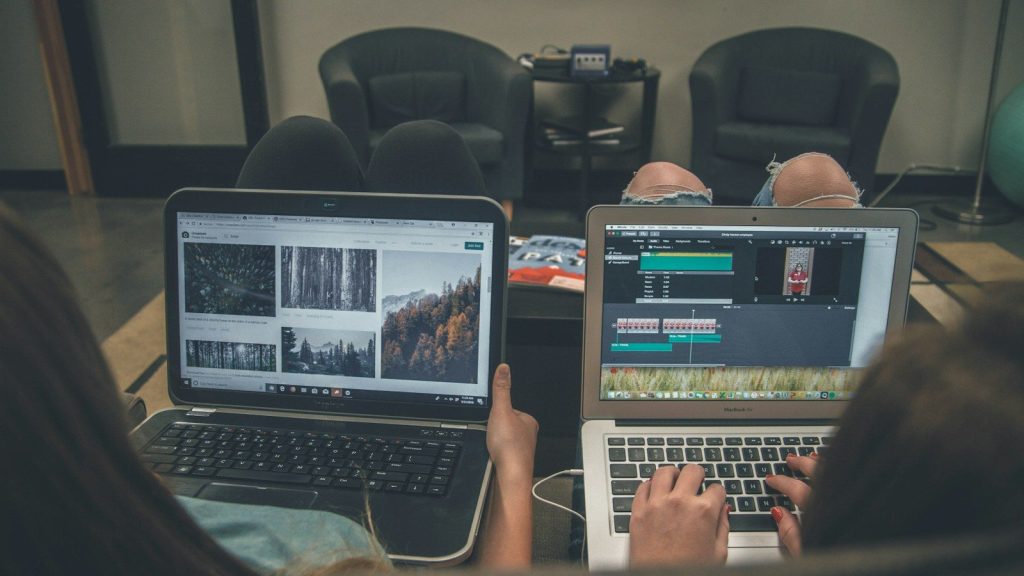 Two people using laptops.