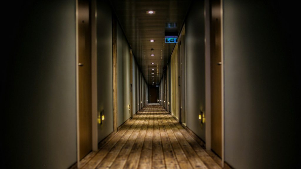 An empty hallway of a hotel.