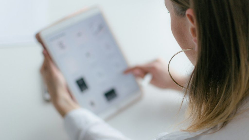 A woman using a tablet watching a calendar.