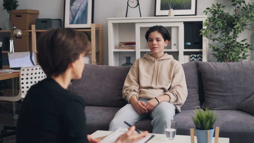 A woman sitting on a couch taking therapy.