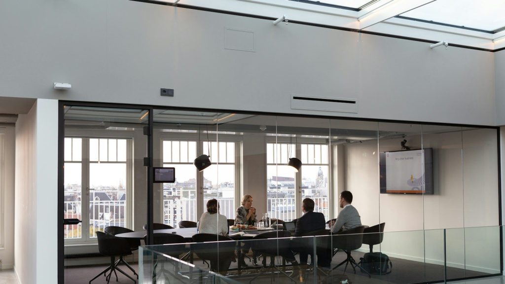 People sitting on chairs inside the office.