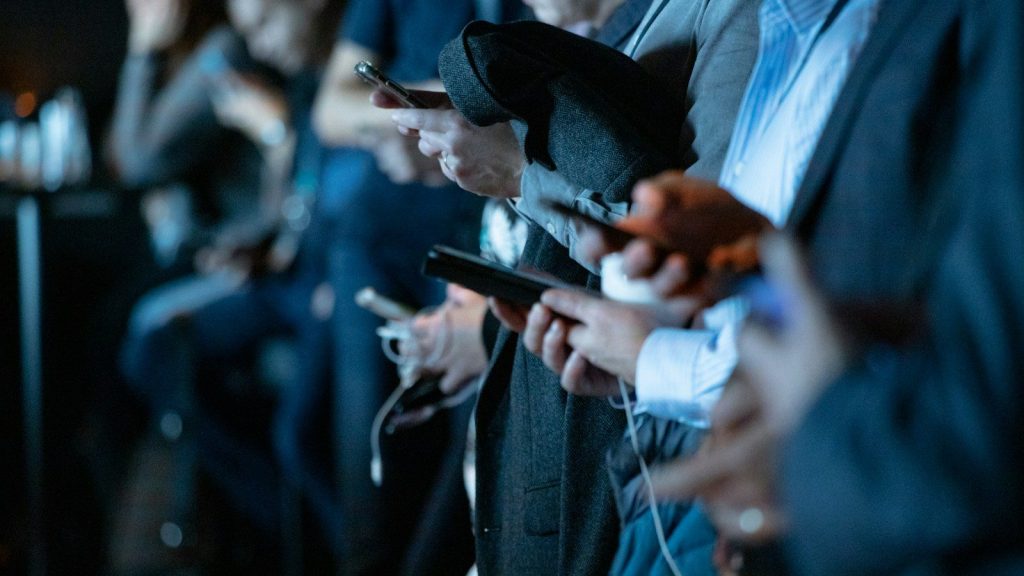 People using phone while standing.