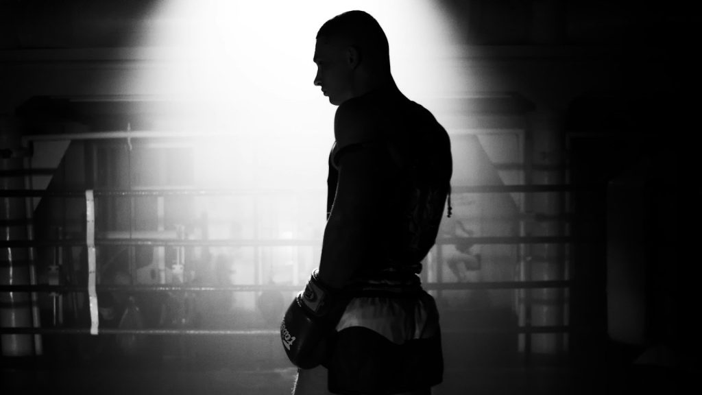 A silhouette of a boxer standing.
