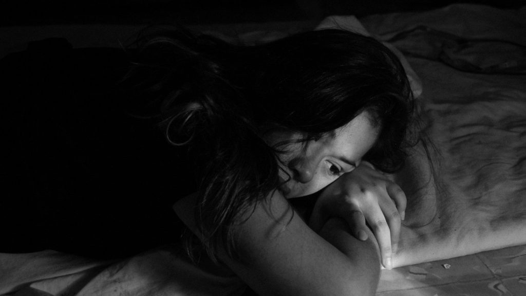 A woman leaning in bed.