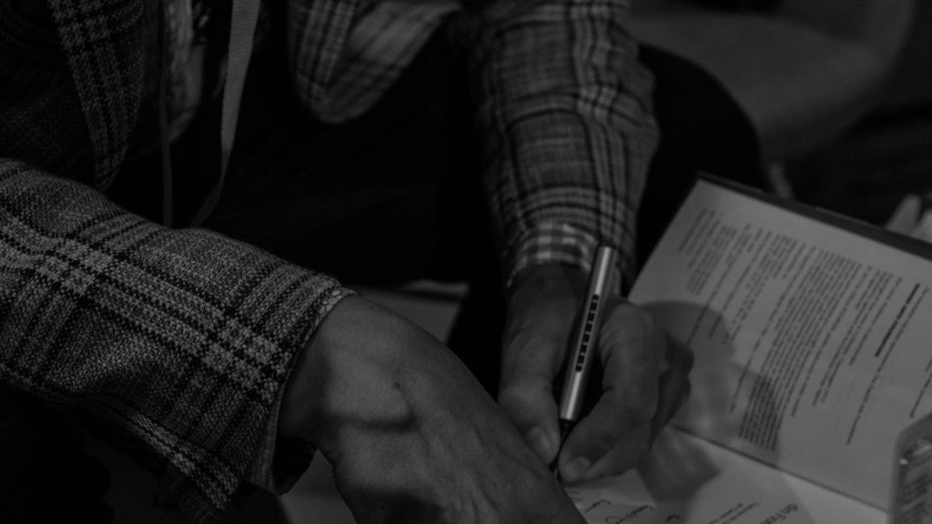 A person signing a book.