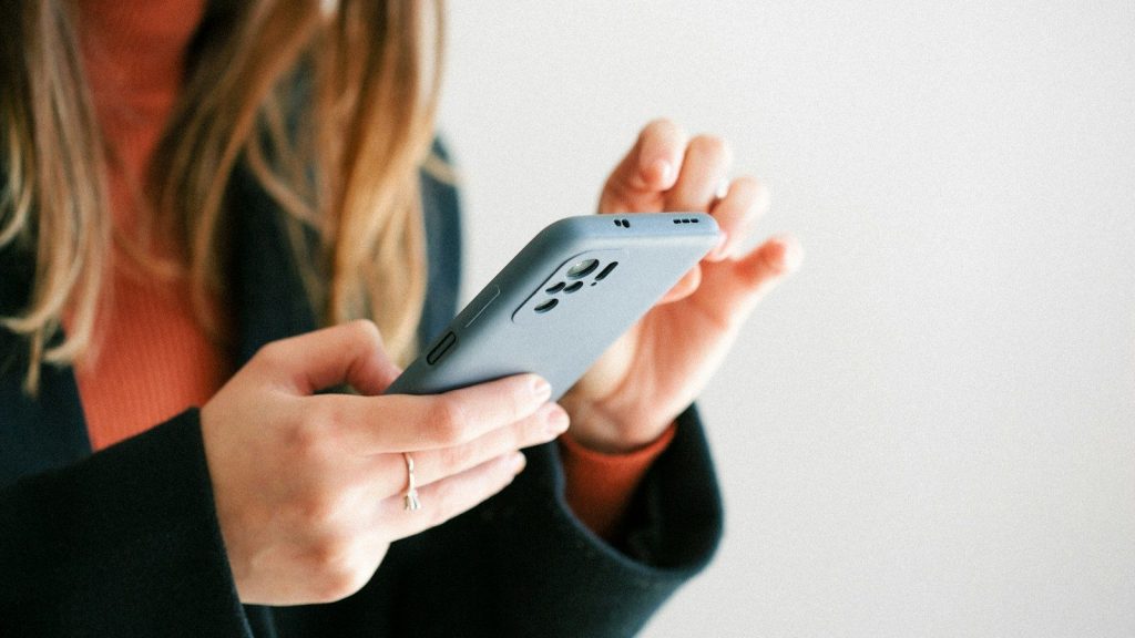 a woman holding a cell phone in her hands