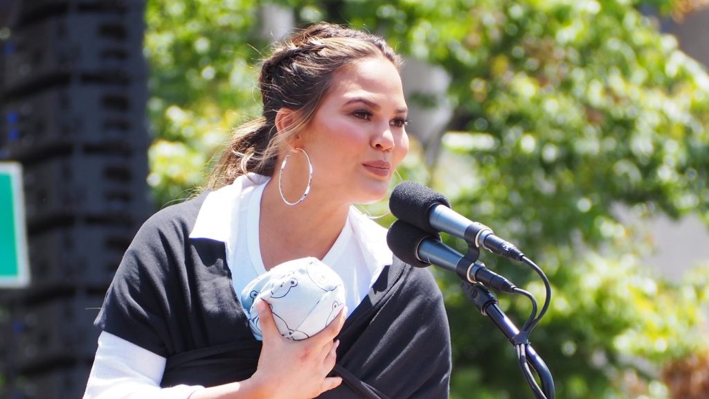 Chrissy Teigen speaking at a campaign.