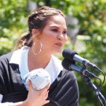 Chrissy Teigen speaking at a campaign.