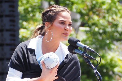 Chrissy Teigen speaking at a campaign.