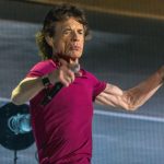 Mick Jagger performing at a live concert.