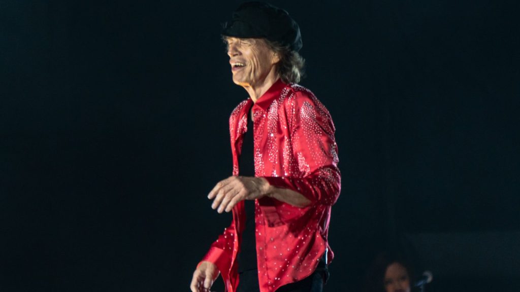 Mick Jagger performing at a live concert.