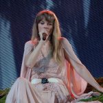Taylor Swift performing at a live concert.