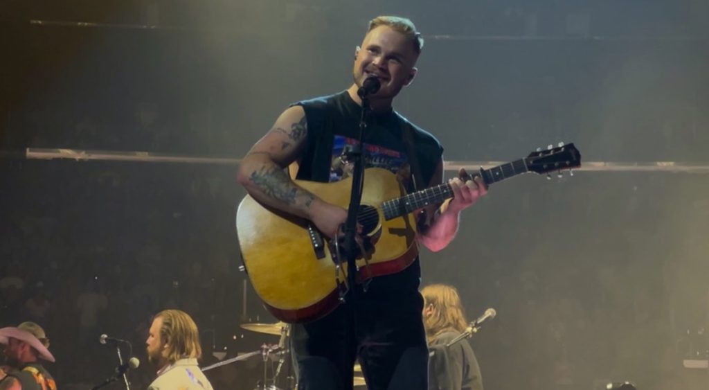 Zach Bryan performing live.