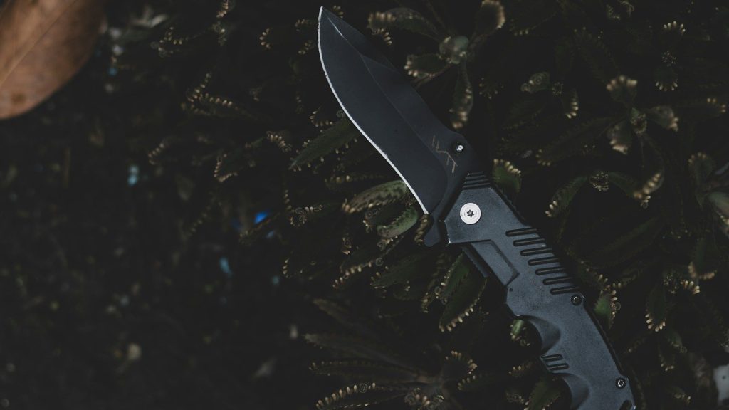 A knife on a green surface.