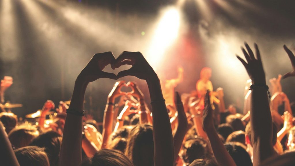 Person performing heart hand gesture.