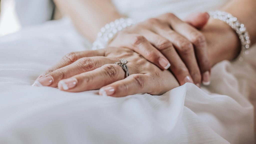 person wearing silver ring on ring finger