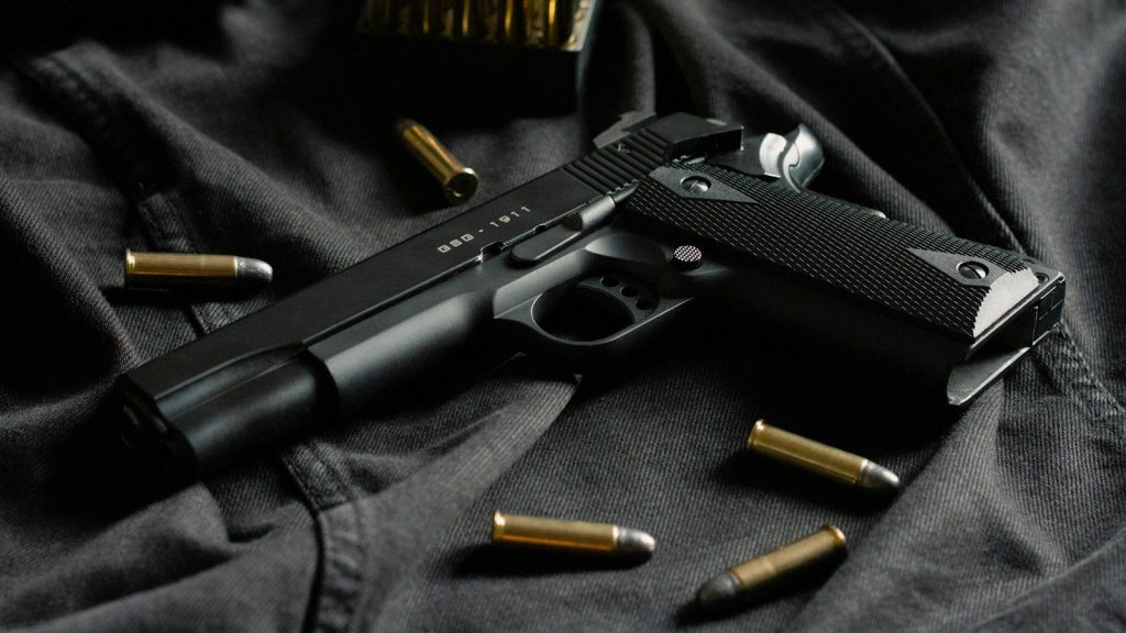 black semi automatic pistol on black textile