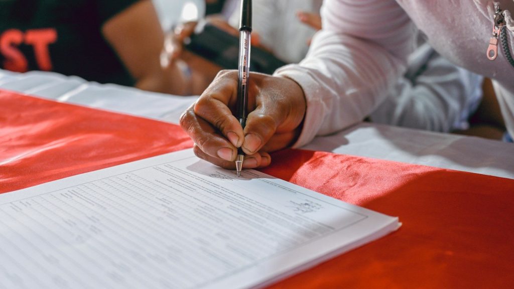 A man signing a contract.
