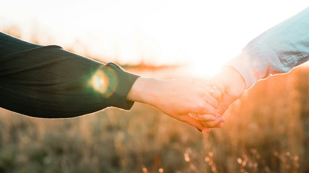 A couple holding hands.