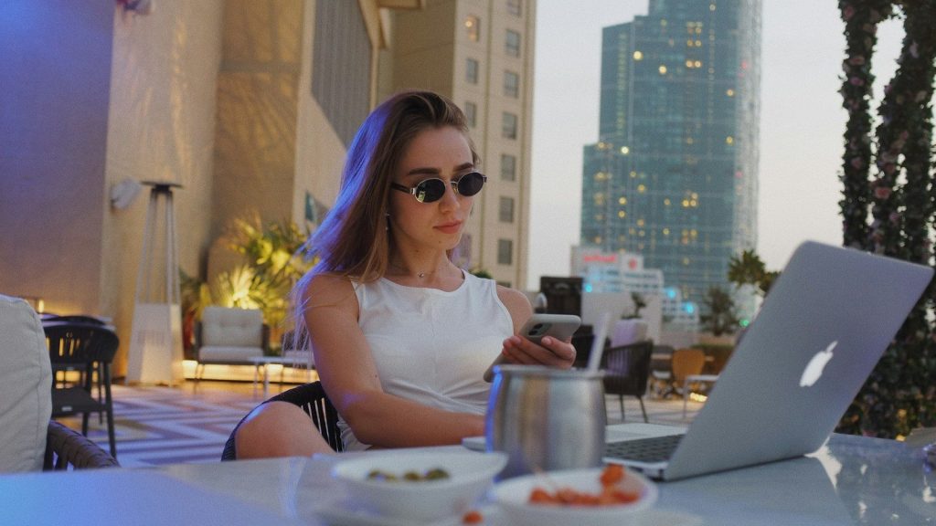 Woman working on a laptop in a luxury setting.