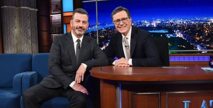 Jimmy Kimmel and Stephen Colbert together on a late night talk show set.