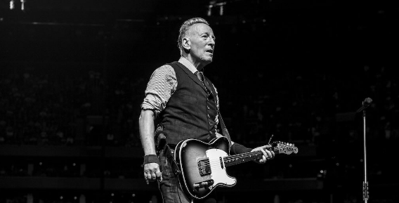 Bruce Springsteen performing live on stage.