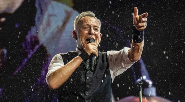 Bruce Springsteen performing live on stage.