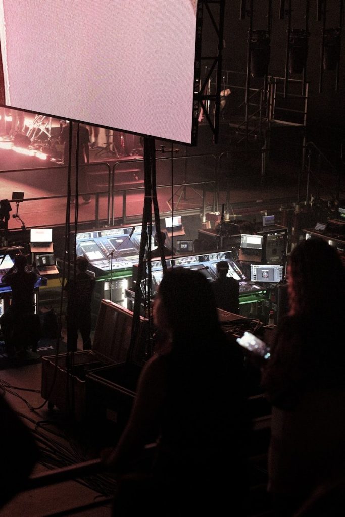 People working at a control desk with screens.