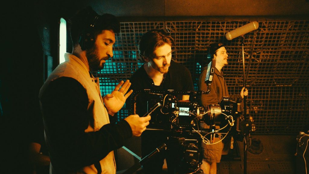 Film crew operates cameras during production.