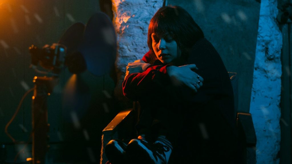 Actress performs an emotional scene during a film shoot.